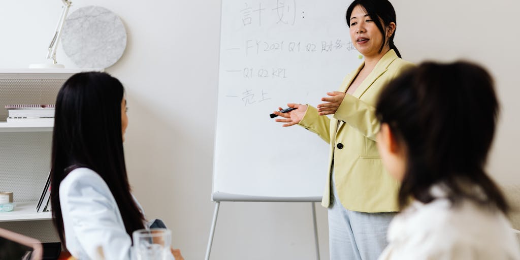 An overhead view of a brainstorming session where a diverse team is gathered around a table filled with sticky notes, charts, and laptops. One of the sticky notes prominently displays key performance indicators (KPIs) written in bold letters, symbolizing collaborative business development efforts.