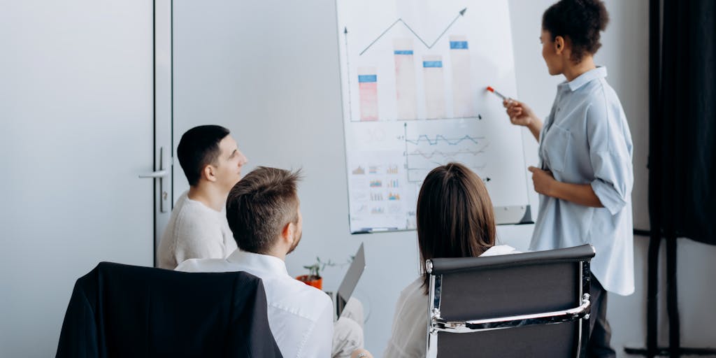 A vibrant office scene where a diverse team of sales professionals is engaged in a brainstorming session. They are surrounded by digital screens displaying analytics and sales metrics, with sticky notes and charts on the walls. The atmosphere is energetic, showcasing collaboration and innovation in sales engagement.