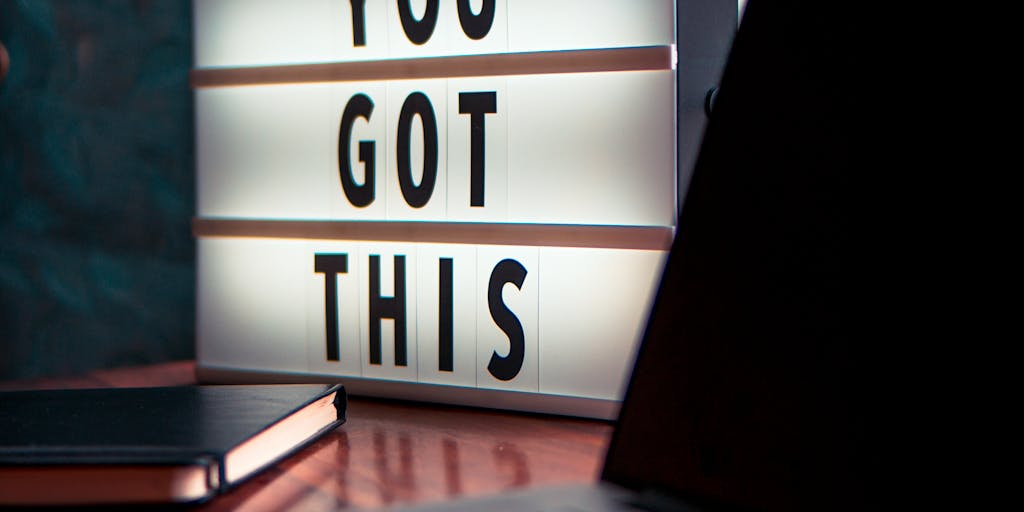 A close-up shot of a laptop screen displaying a LinkedIn profile with a cold message being typed out. The background features a cozy workspace with a coffee cup and a notepad, symbolizing the casual yet professional nature of networking.