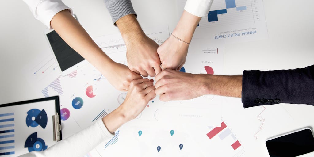 A dynamic image of a diverse group of professionals in a meeting, discussing strategies while looking at a screen that displays Rocketreach analytics. The focus should be on collaboration and the power of data-driven decision-making.