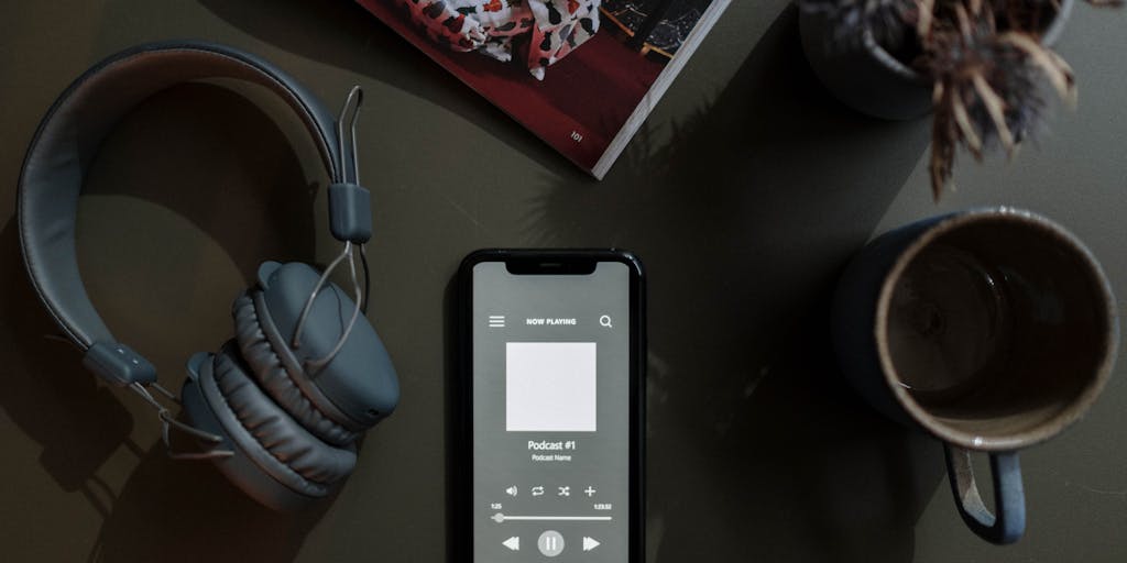 A close-up shot of a smartphone displaying the Dripify app interface, with a coffee cup and a notepad in the background. The scene should convey a productive workspace, highlighting the app's user-friendly design and functionality.
