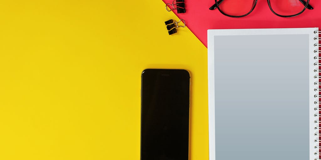 An artistic flat lay of various digital marketing tools and resources, including a laptop with the Dripify website open, colorful sticky notes, and a plant. This composition should reflect creativity and the essence of digital marketing.