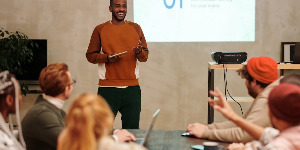 A close-up shot of a diverse group of people sitting in a modern office space, intently watching a presentation on a large screen. The screen displays colorful graphs and analytics related to audience engagement. The expressions on their faces reflect curiosity and engagement, showcasing the importance of audience insights in decision-making.