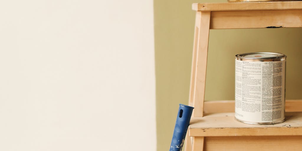A conceptual photo of a scale balancing a gold coin on one side and a dripping paint bucket on the other, illustrating the balance between cost and creativity in pricing. The background is a gradient of colors to enhance the artistic theme.