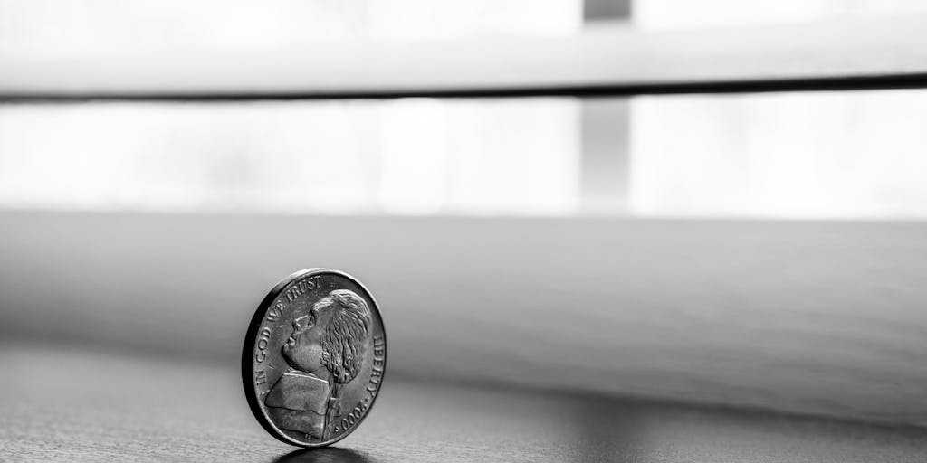 An artistic representation of a scale balancing coins on one side and a Seamless.ai logo on the other, symbolizing the value of investment in the service. The background should be a blurred office environment to keep the focus on the scale.