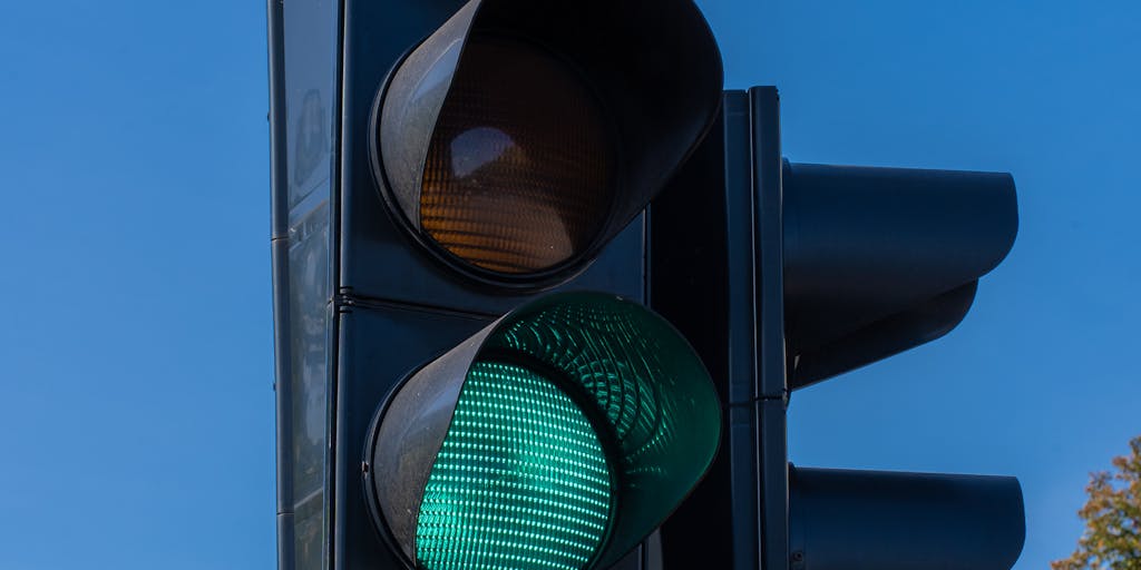 A conceptual image of a person standing at a crossroads with two signs pointing in different directions labeled 'Affordable' and 'Premium'. The background should be a vibrant cityscape, symbolizing the choices businesses face with pricing.