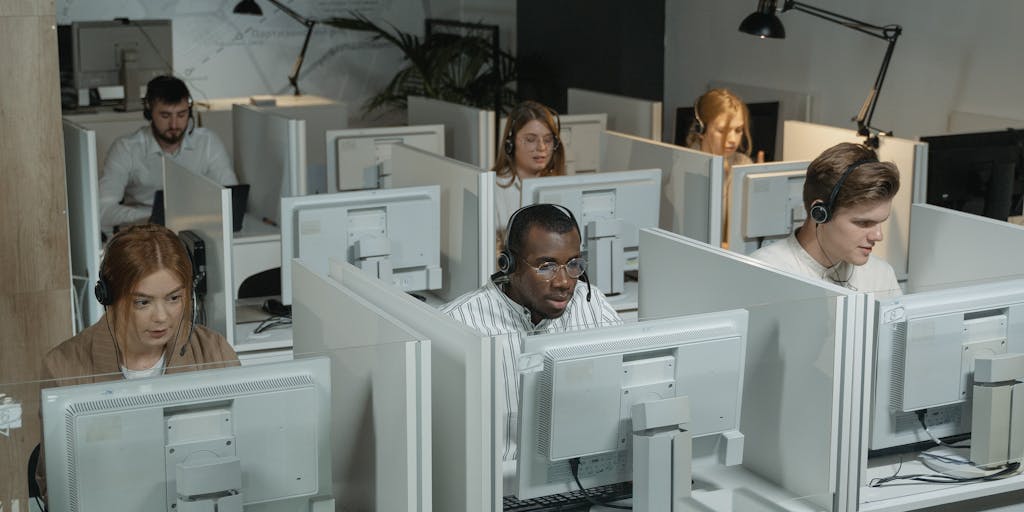 A visually striking image of a person sitting at a desk, surrounded by multiple screens displaying Waalaxy's pricing plans. The screens should show colorful graphs and charts, emphasizing the value of the service. The person is deep in thought, with a notepad filled with calculations and notes, symbolizing the decision-making process.