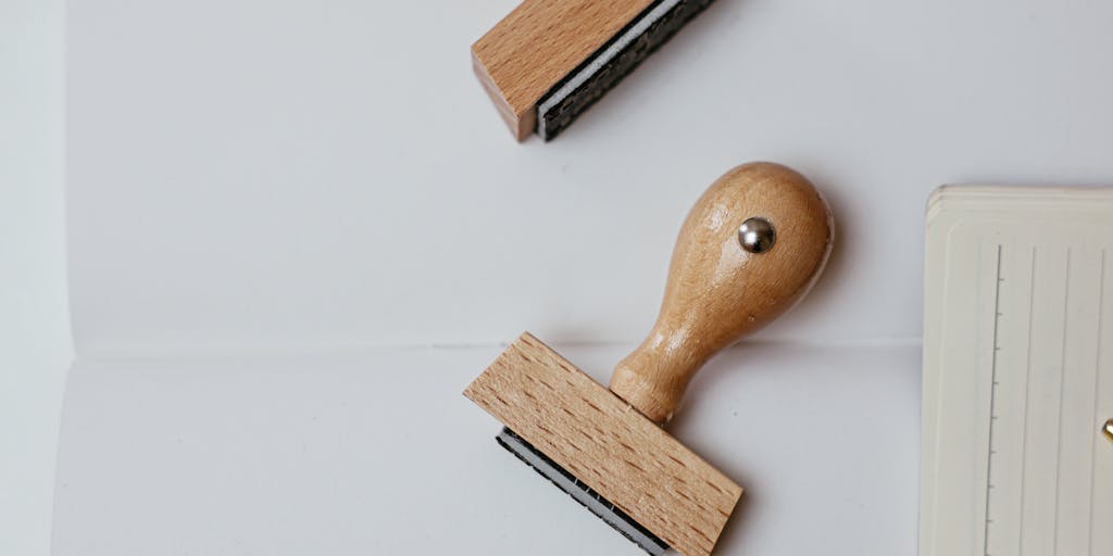 An artistic flat lay of various tools and items that represent lead generation, such as a calculator, notepad, and AeroLeads logo, arranged around a printed pricing plan. The background should be a wooden table to add warmth.