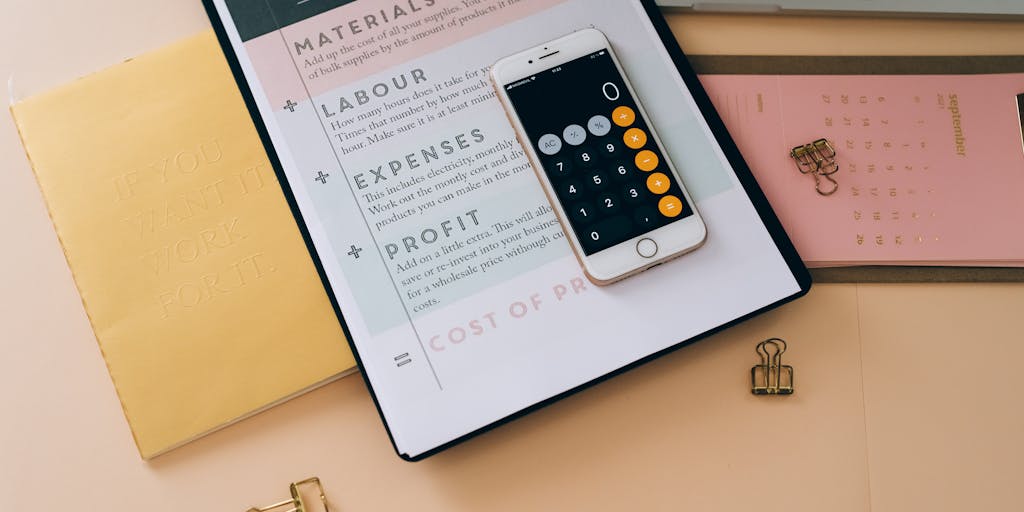 A close-up shot of a hand holding a smartphone displaying the Snov.io pricing page, with a blurred background of a modern office setting. The focus is on the screen, highlighting the pricing tiers and features, while the office environment suggests a professional context.