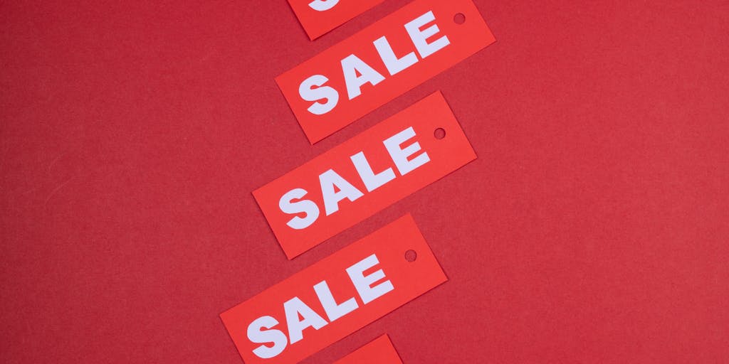 A dynamic image of a diverse group of people in a retail store, each interacting with digital price tags on products. The tags display real-time pricing updates, showcasing the concept of seamless pricing in a vibrant shopping environment.