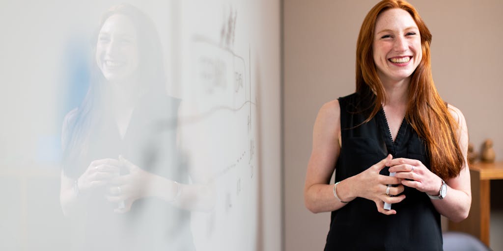A dynamic image of a person standing in front of a whiteboard filled with graphs and pricing strategies, pointing at a section labeled 'Leadleaper Pricing'. The person is dressed in business casual attire, exuding confidence and professionalism, with a bright light illuminating the board.