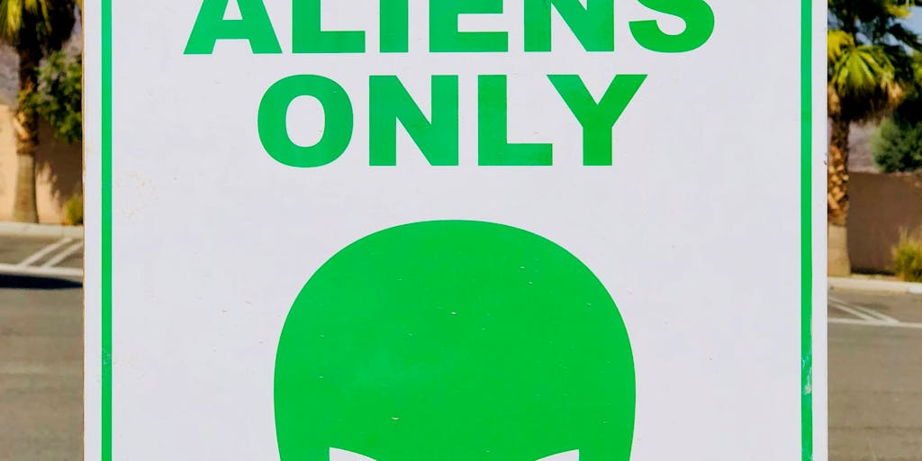 A whimsical illustration of a Reddit alien character holding a sign with Salesloft pricing details, surrounded by speech bubbles containing user comments and questions about the pricing. The background should be vibrant and playful, capturing the essence of online discussions.