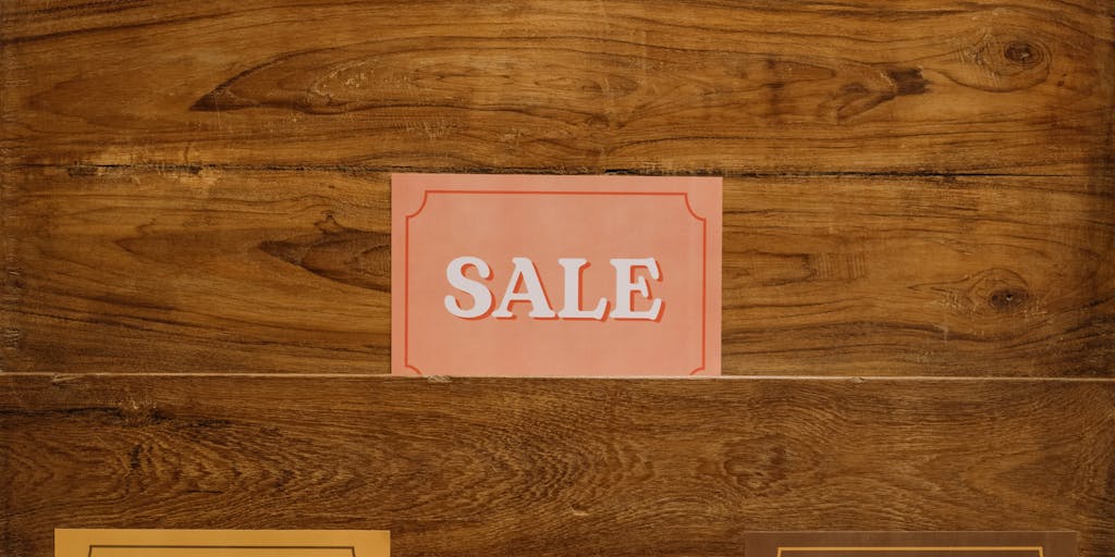 A split image showing two contrasting price tags merging into one. On one side, a high-end luxury item with a gold price tag, and on the other, a budget-friendly item with a simple white price tag. The center of the image features a blurred effect where the two tags meet, symbolizing the concept of merge pricing.