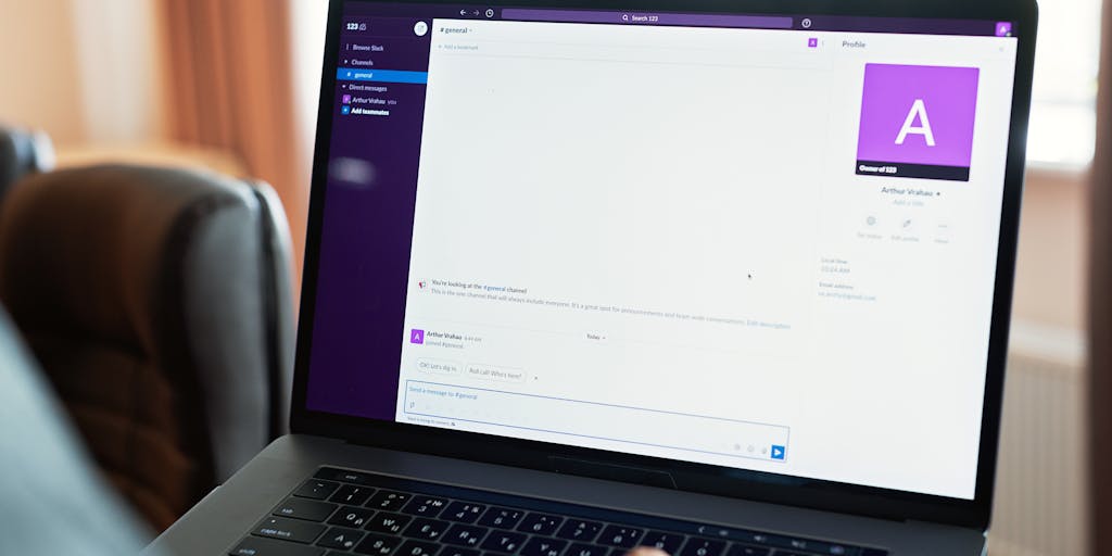 A close-up shot of a computer screen displaying a LinkedIn profile with various data points highlighted, such as connections, endorsements, and job history. The background features a person typing on a laptop, symbolizing the act of scraping data. The lighting is warm to create an inviting atmosphere.