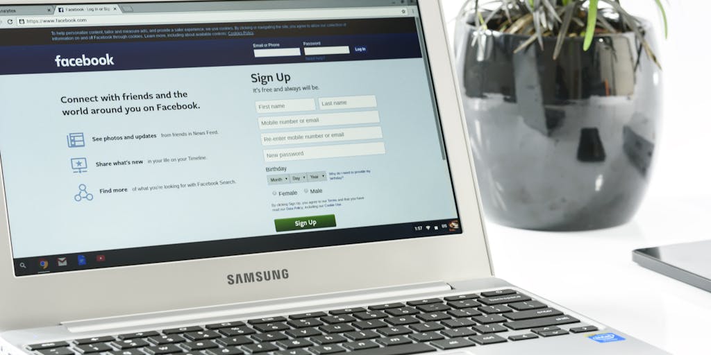 A close-up shot of a laptop screen displaying a LinkedIn profile with a highlighted 'Connect' button. In the background, a person is seen thoughtfully typing on a keyboard, symbolizing the act of reaching out to potential connections. The lighting is warm and inviting, creating a professional yet approachable atmosphere.