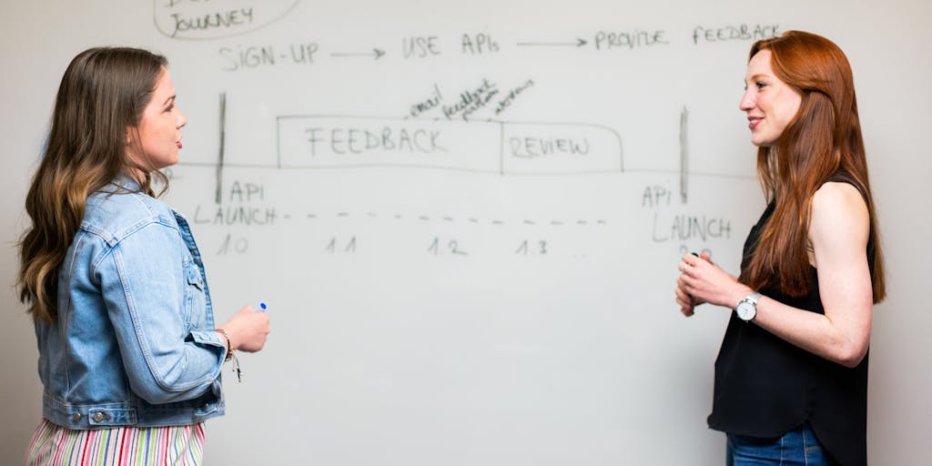A creative workspace scene featuring a laptop with LinkedIn open, surrounded by notes and sketches of API integration ideas. The setting should convey a sense of brainstorming and innovation, with coffee cups and tech gadgets in the background.