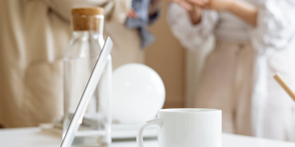 An overhead view of a diverse group of professionals gathered around a table, each with their devices open to LinkedIn. They are engaged in a discussion about networking strategies, with sticky notes and charts scattered around, representing collaboration and the power of premium membership.