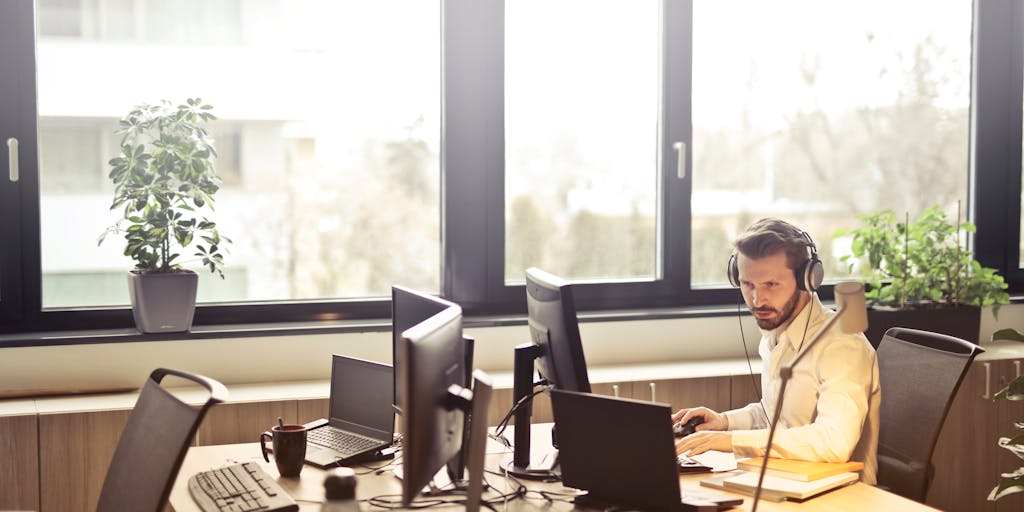 A split image showing a salesperson on one side, confidently making a call with a headset, and on the other side, a screen displaying LinkedIn Sales Navigator analytics and insights. This juxtaposition highlights the connection between personal interaction and data-driven decision-making.