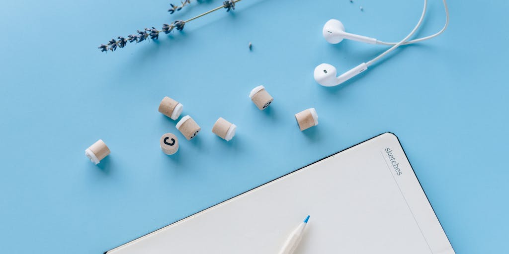 A creative flat lay of a desk setup featuring a smartphone displaying the LinkedIn Sales Navigator app, a notebook with handwritten notes, a coffee cup, and a plant. This composition conveys a modern, organized workspace that emphasizes productivity and networking.