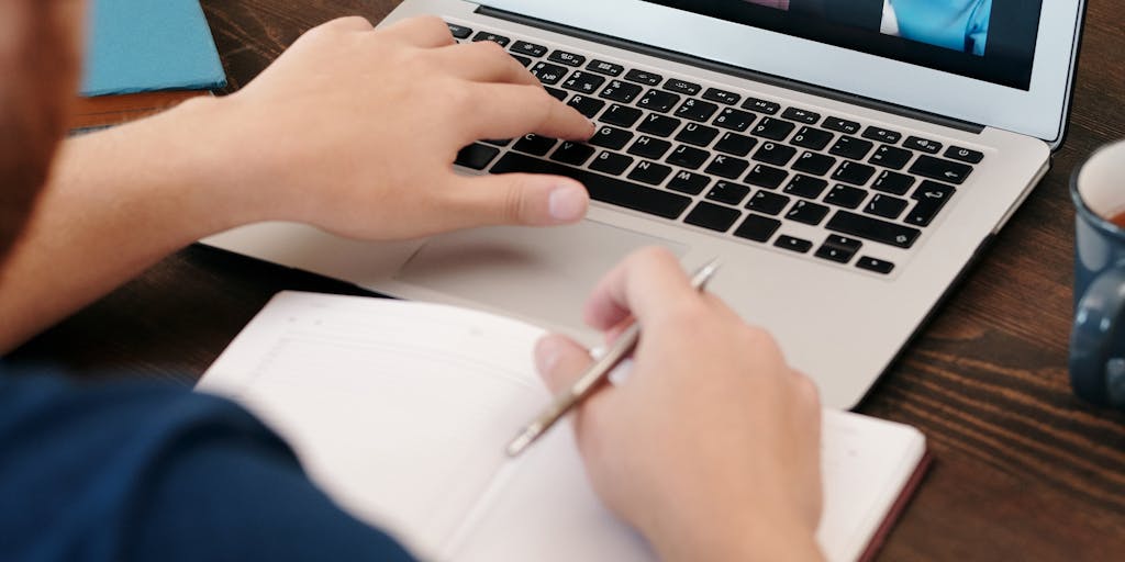 A split-screen image showing two individuals in different locations (one in an office, the other at home) using their devices to connect on LinkedIn. Each side displays their LinkedIn profiles on the screens, highlighting the power of remote networking.