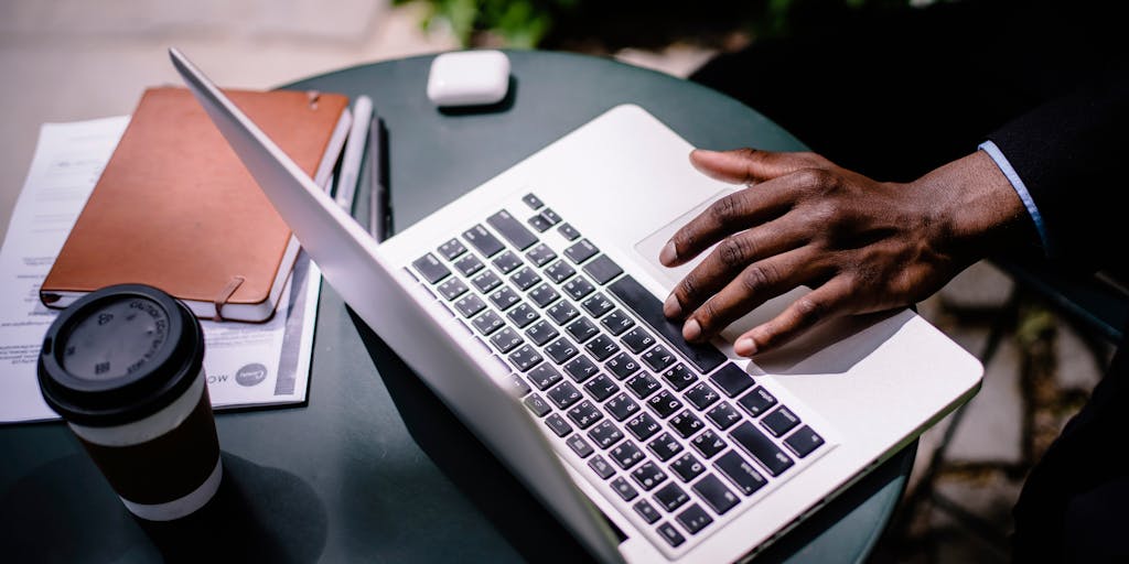 A creative split image showing one side with a person scrolling through LinkedIn on their phone in a cozy café, and the other side depicting a successful job interview in a modern office. This juxtaposition highlights the journey from finding candidates online to real-world hiring.