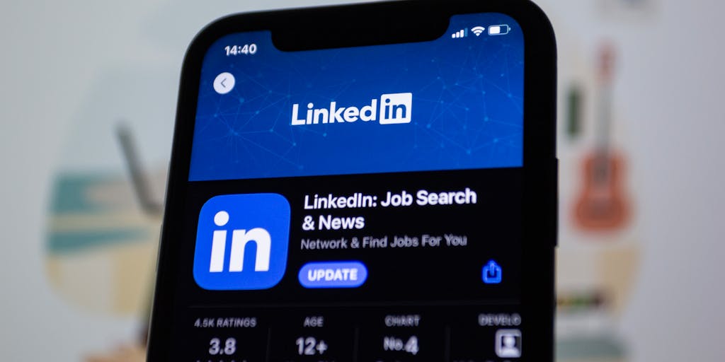 A close-up shot of a laptop screen displaying a LinkedIn profile with a professional photo, a well-crafted headline, and a list of skills related to eCommerce. In the background, a person is seen engaging in a video call, symbolizing networking and client outreach.