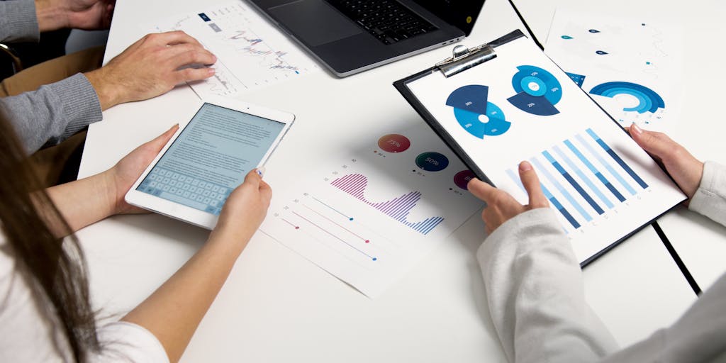 A close-up shot of a computer screen displaying a complex email scraping tool interface, with colorful graphs and data visualizations. The background features a blurred office environment, emphasizing a tech-savvy workspace.