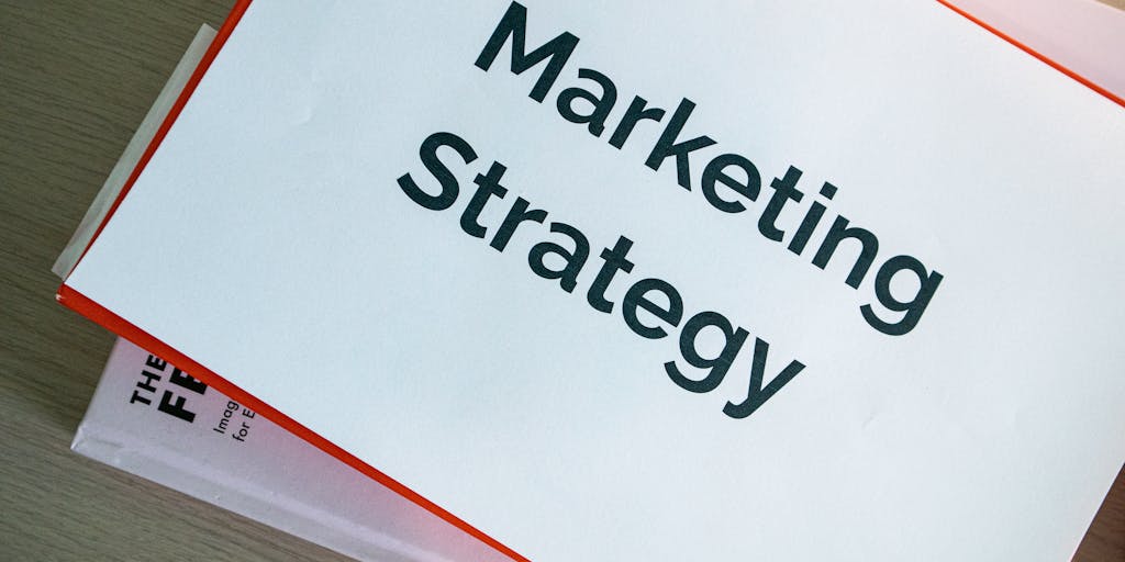 An overhead view of a desk cluttered with marketing materials, including a notebook with sketches of target personas, a smartphone displaying LinkedIn messages, and a coffee cup. This composition represents the brainstorming and planning phase of Account Based Marketing.