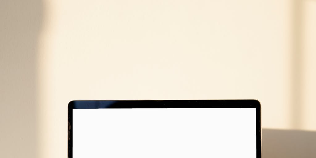 A close-up shot of a laptop screen displaying a well-designed LinkedIn InMail template, with a coffee cup and a notepad beside it. The background should be a cozy office setting, emphasizing a professional yet inviting atmosphere.