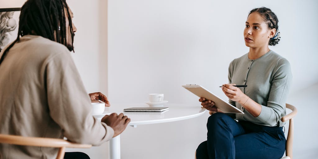 A split-screen image showing two scenarios: on one side, a recruiter using LinkedIn Recruiter on a desktop, and on the other side, a job seeker optimizing their LinkedIn profile on a mobile device. This visual contrast highlights the interaction between recruiters and candidates.