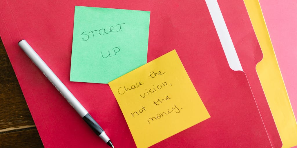 An overhead view of a person sitting at a desk, surrounded by sticky notes with tips for cold messaging on LinkedIn. The notes include phrases like 'Personalize your message' and 'Be concise', creating a colorful and engaging visual.