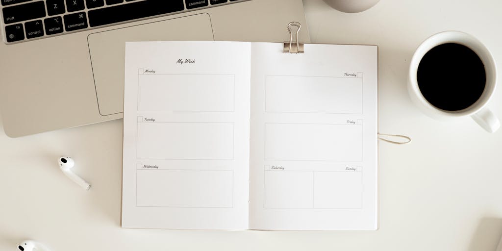 An overhead view of a desk cluttered with sticky notes, a smartphone showing the LinkedIn app, and a calendar marked with important sales dates. The photo captures the essence of planning and staying organized while using Sales Navigator alerts.