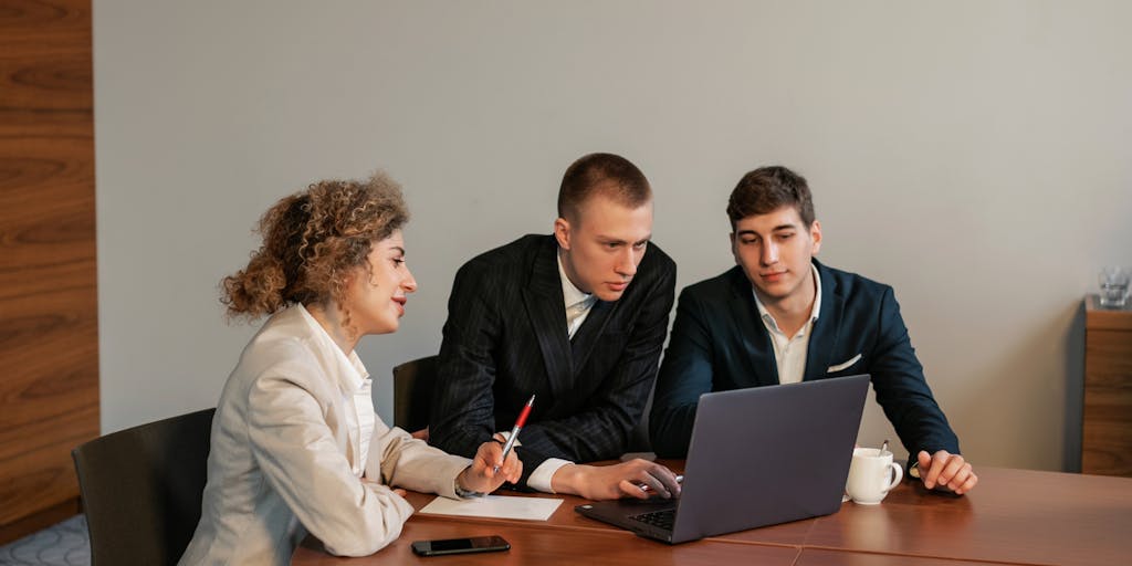 A candid shot of a diverse team in a brainstorming session, surrounded by sticky notes and charts on a whiteboard. The team should be discussing strategies for multichannel prospecting, showcasing collaboration and innovation in a vibrant office environment.