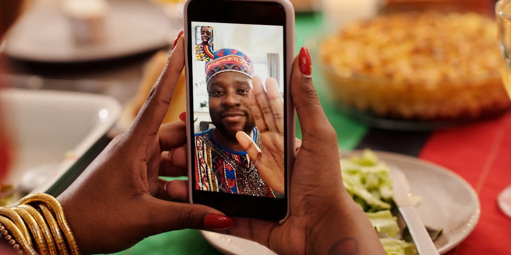 A close-up shot of a hand holding a smartphone displaying the PieSync pricing page, with a freshly baked pie in the foreground. The pie is beautifully arranged with a flaky crust and vibrant fruit filling, symbolizing the sweetness of choosing the right pricing plan.